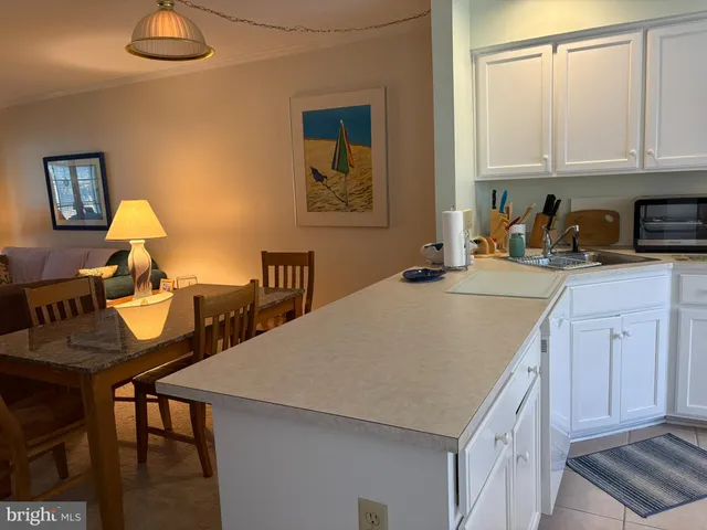 a kitchen with a table chairs and a refrigerator