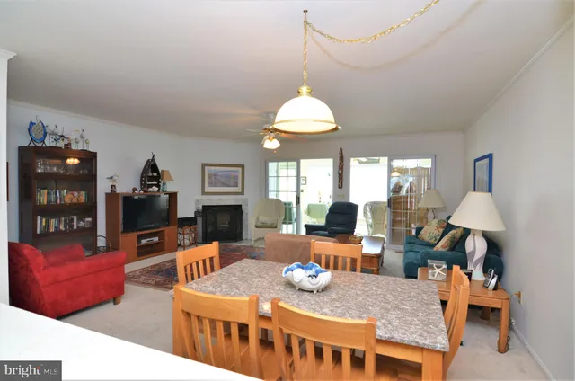 a view of a dining room with furniture a chandelier and wooden floor