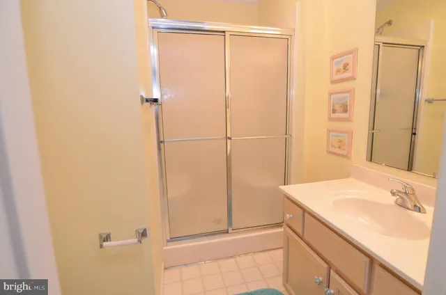 a bathroom with a granite countertop shower and a sink