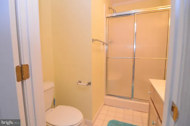 a bathroom with a shower a toilet and a sink