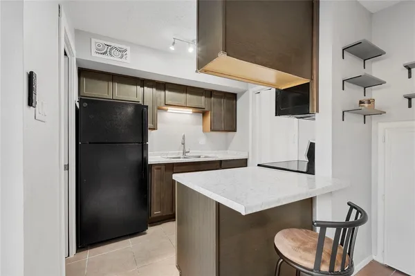 a kitchen with stainless steel appliances a refrigerator and a sink