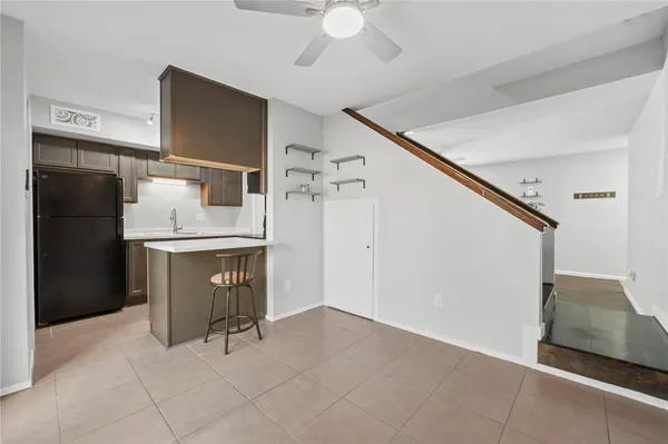a kitchen with a refrigerator and a sink