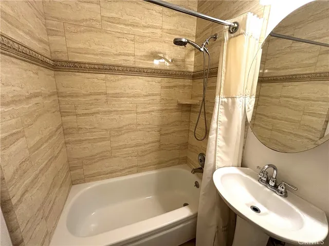 a bathroom with a sink and shower