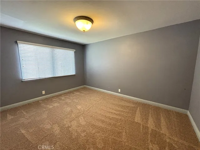 an empty room with a empty space and a window