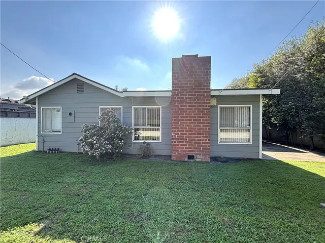 a front view of house with yard and trees
