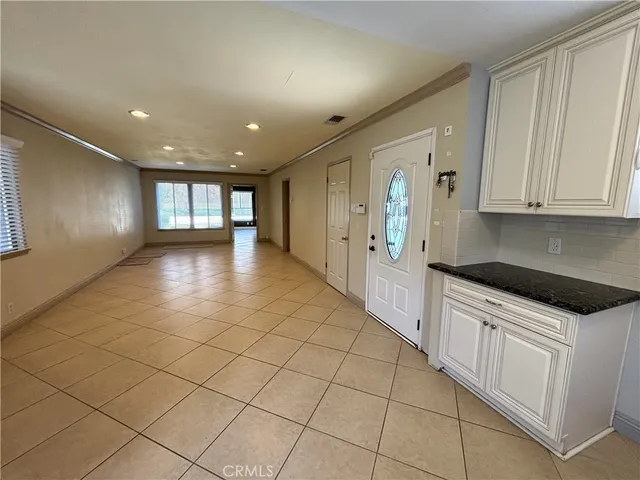 a large kitchen with white cabinets