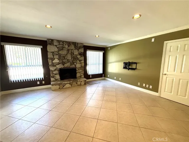 a view of a livingroom with a fireplace and window