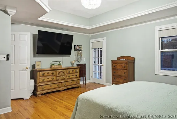 a bedroom with furniture and flat screen tv