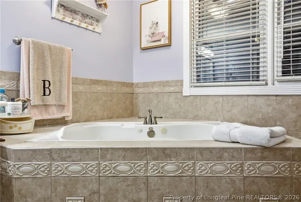 a bathroom with bathtub and window