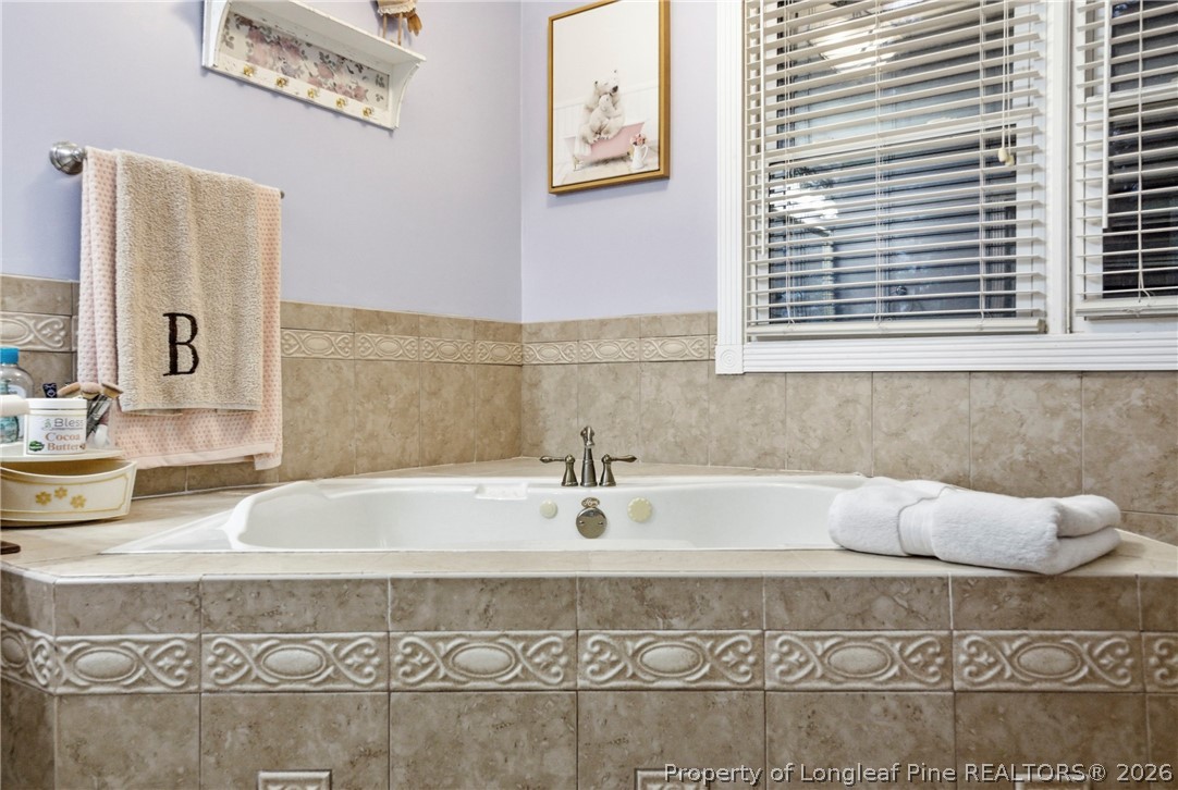 732 County Line Road Roseboro, NC 28382 - Photo 14 of 30 a bathroom with bathtub and window