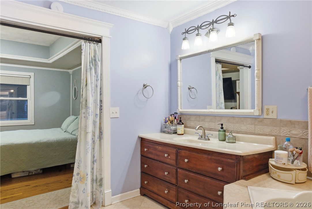 732 County Line Road Roseboro, NC 28382 - Photo 16 of 30 a en suite bathroom with a double vanity sink and a mirror