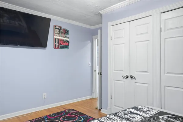 a bedroom with a bed and a view of bathroom