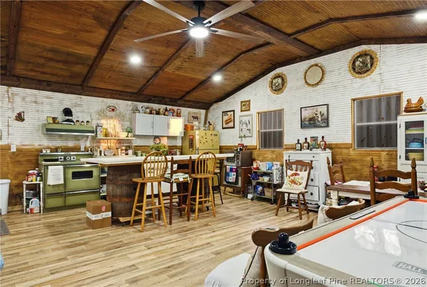 a view of a dining hall with lots of chairs and wooden floor