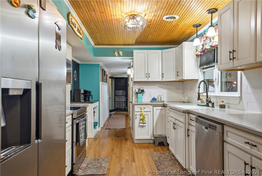 732 County Line Road Roseboro, NC 28382 - Photo 5 of 30 a kitchen with stainless steel appliances granite countertop a sink a stove and refrigerator