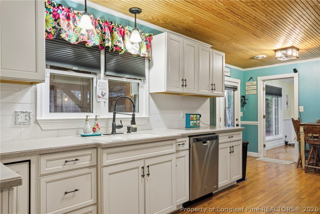 732 County Line Road Roseboro, NC 28382 - Photo 6 of 30 a kitchen with granite countertop white cabinets and window