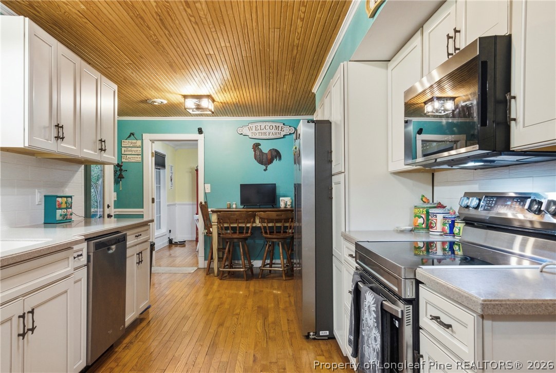 732 County Line Road Roseboro, NC 28382 - Photo 7 of 30 a kitchen with stainless steel appliances granite countertop a sink stove and refrigerator