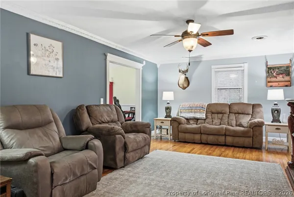 a living room with furniture a bed and a chandelier