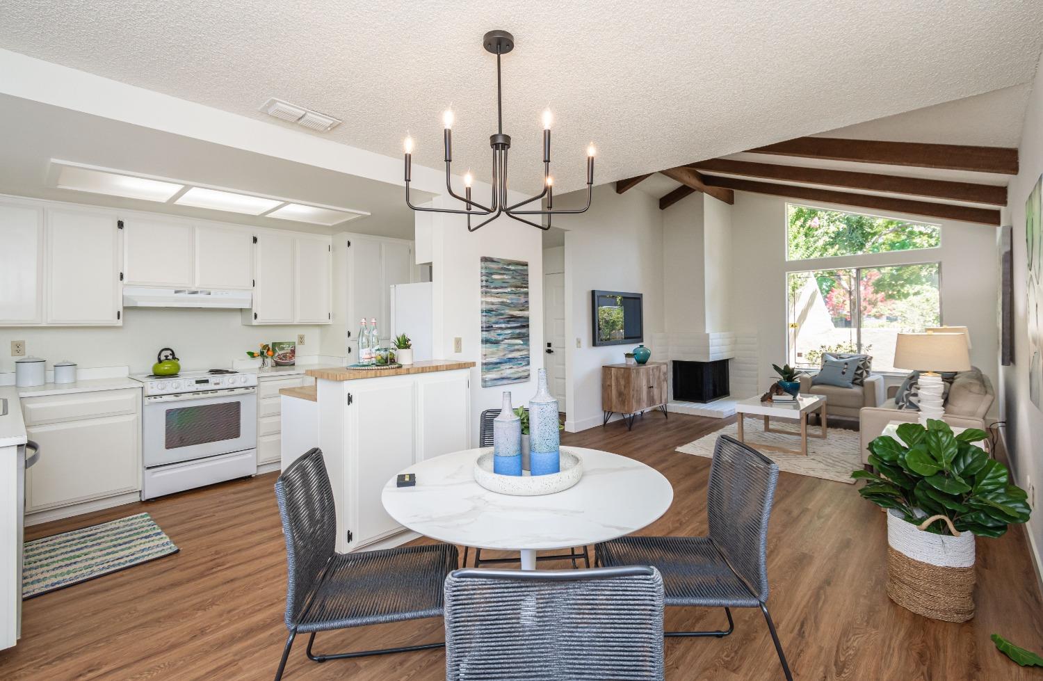1120 Rosa Del Rio Way Sacramento, CA 95822 - Photo 1 of 1 a kitchen with stainless steel appliances a dining table chairs and white cabinets