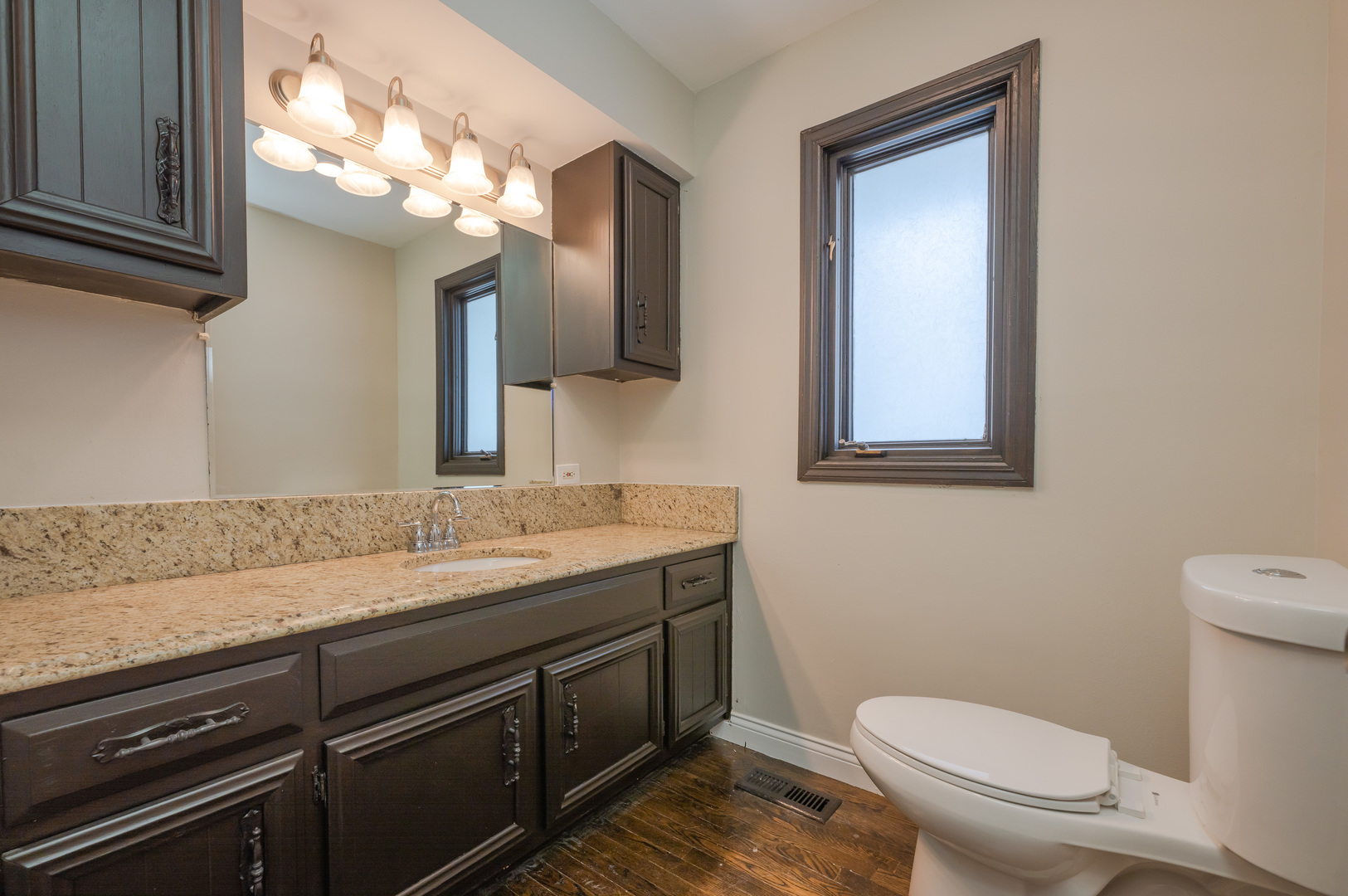 129 Cornwall Drive Crete, IL 60417 - Photo 15 of 52 a bathroom with a granite countertop toilet sink and mirror