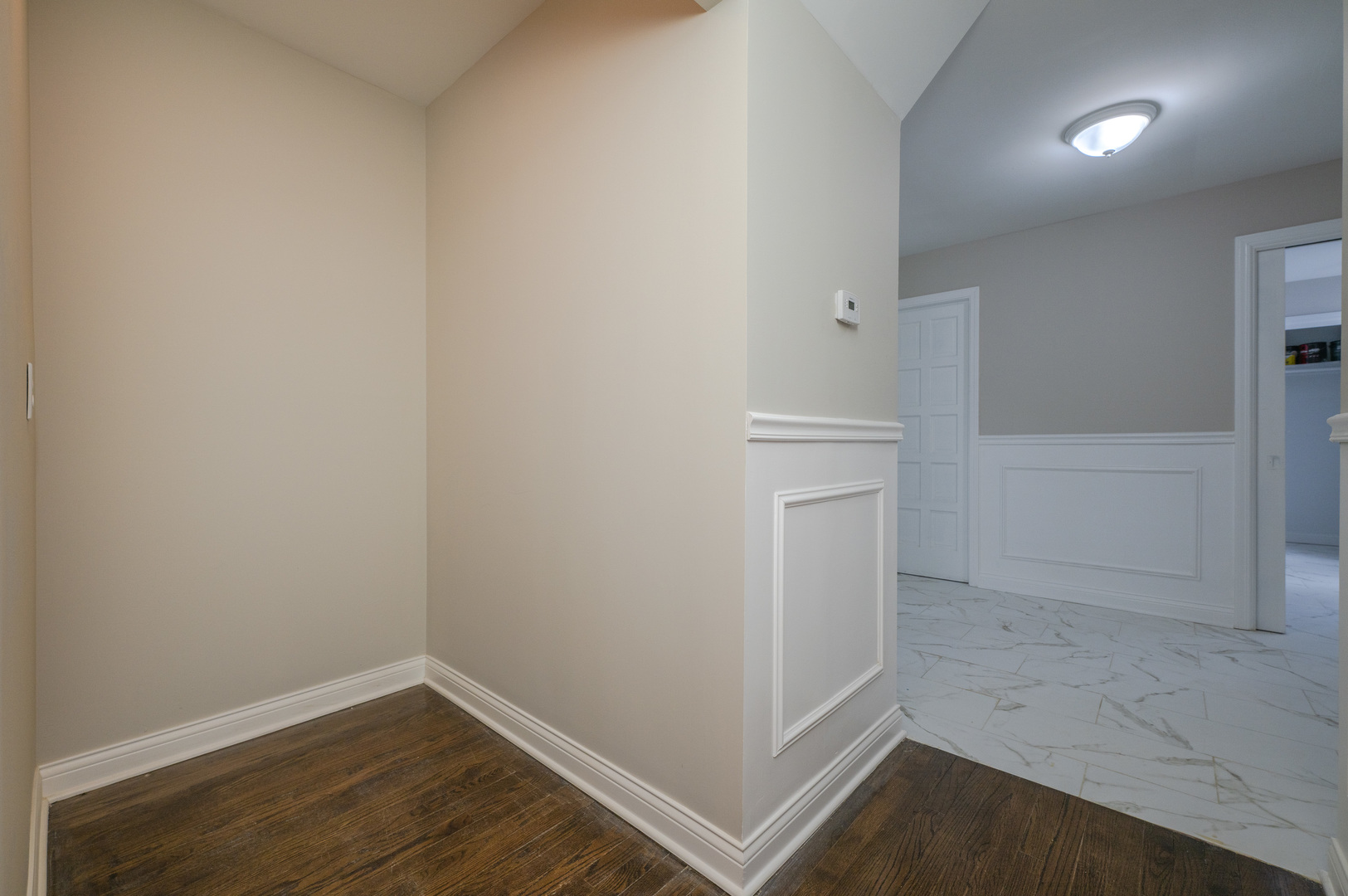 129 Cornwall Drive Crete, IL 60417 - Photo 16 of 52 an empty room with wooden floor and entrance