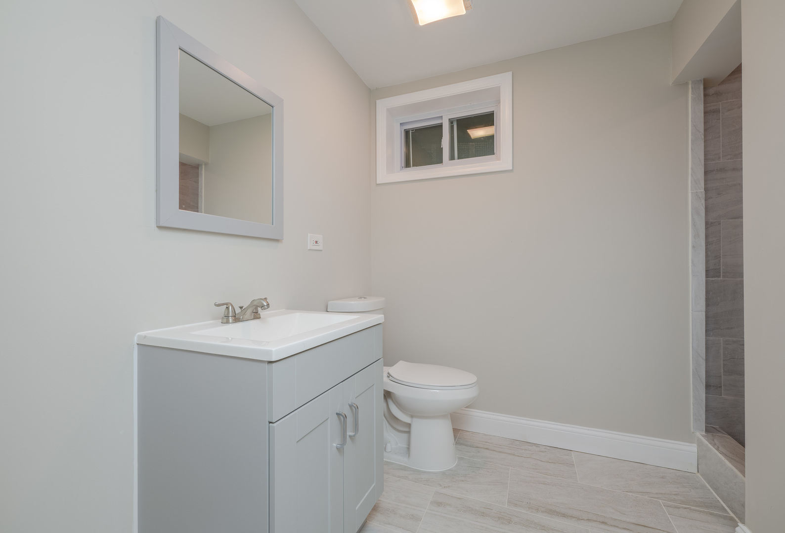 129 Cornwall Drive Crete, IL 60417 - Photo 41 of 52 a bathroom with a toilet sink vanity and mirror