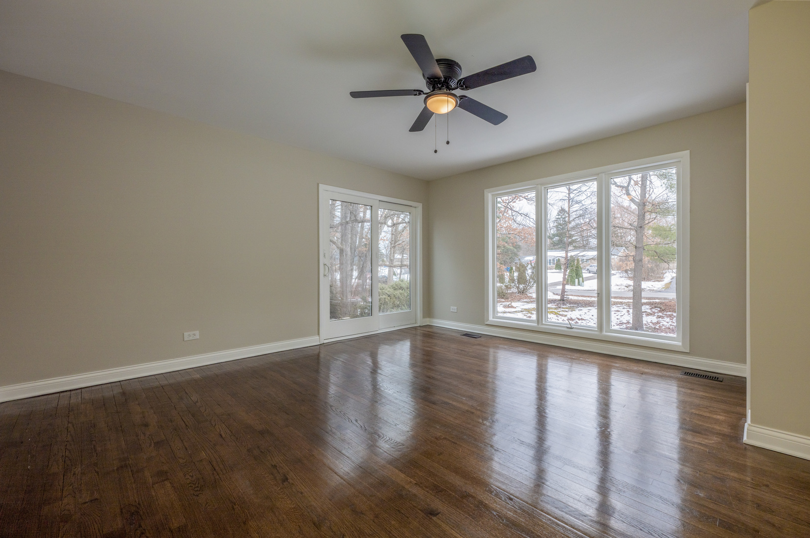 129 Cornwall Drive Crete, IL 60417 - Photo 5 of 52 a view of an empty room with wooden floor and a window