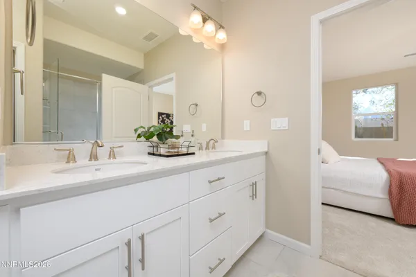 a en suite bathroom with double sink and a mirror