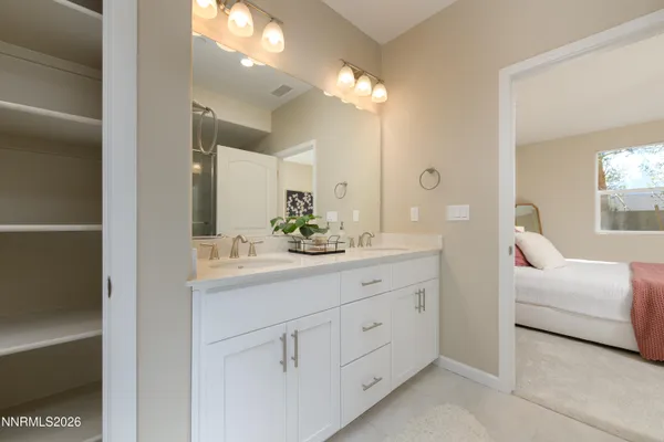 a bathroom with a double vanity sink and mirror