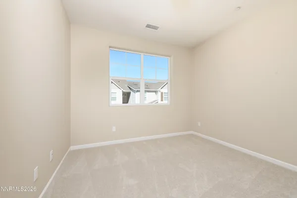 an empty room with closet and a bathroom