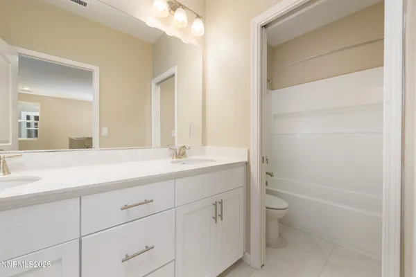 a white bath tub sitting next to a white toilet