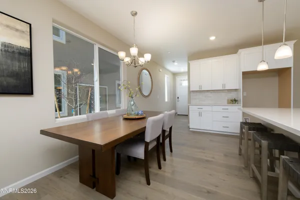 a kitchen with a table chairs sink and cabinets