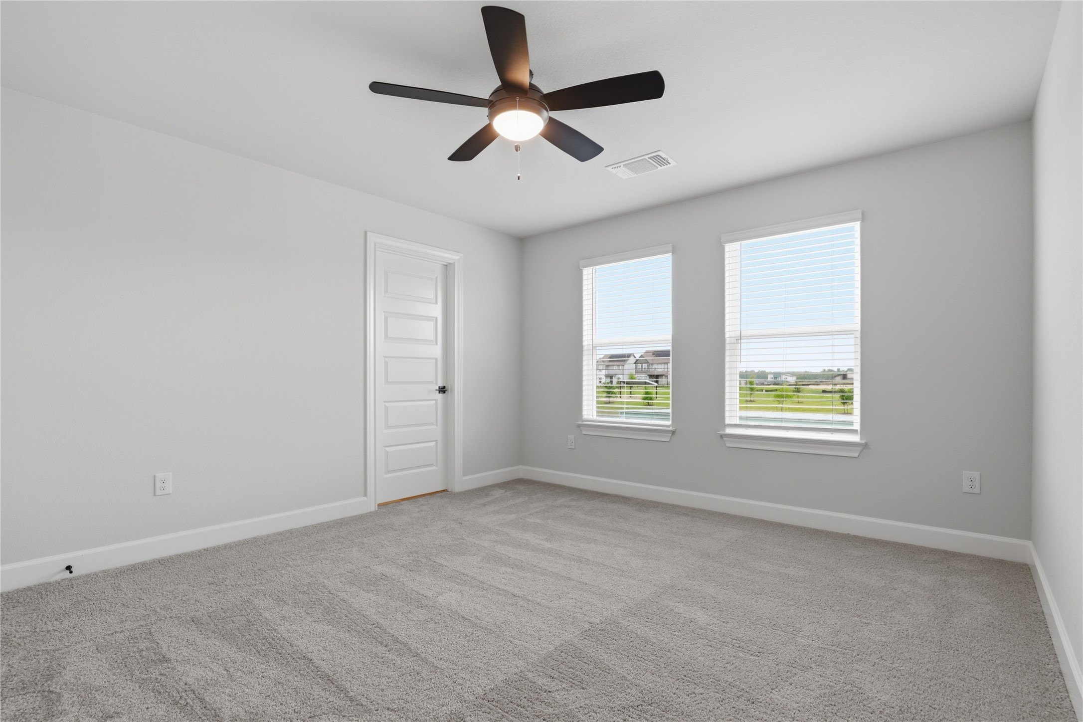 9320 Gladsome Path Manor, TX 78653 - Photo 25 of 34 an empty room with ceiling fan and windows