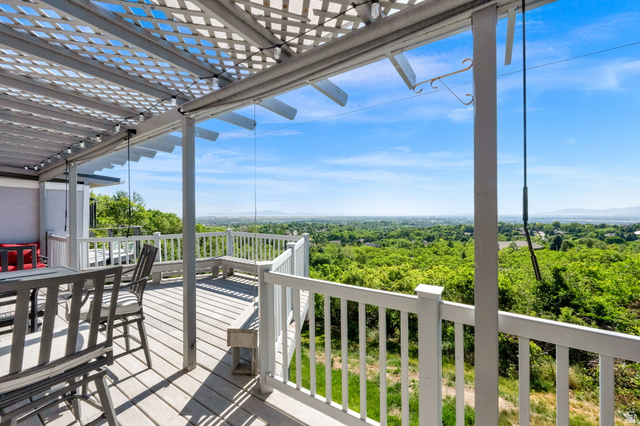 5057 South Ridgedale Drive Ogden, UT 84403 - Photo 11 of 69 Expansive outdoor deck featuring a lattice pergola, white railing, and built-in bench seating