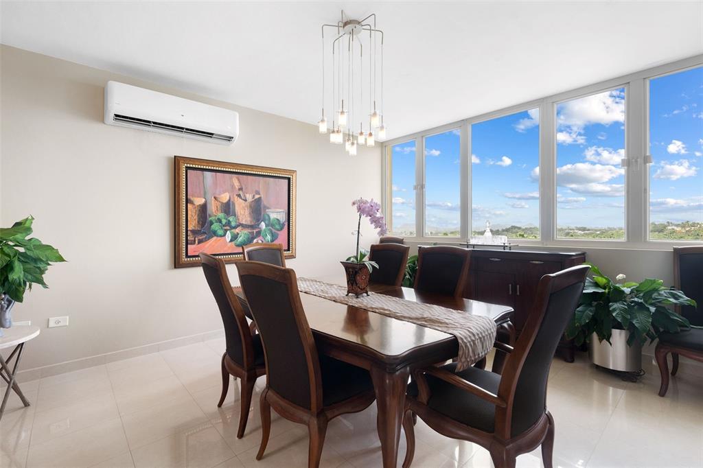 1 Palma Real Avenue, Unit 2 A6 Guaynabo, PR 00969 - Photo 11 of 49 a dining room with furniture a large window and wooden floor