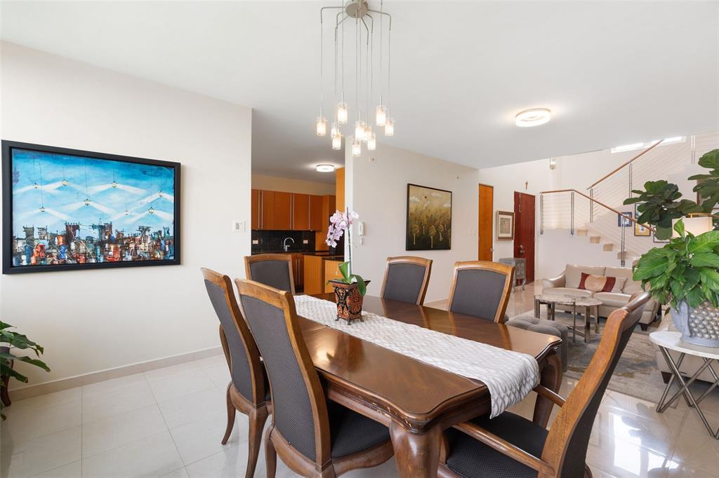 1 Palma Real Avenue, Unit 2 A6 Guaynabo, PR 00969 - Photo 12 of 49 a view of a dining room with furniture a chandelier and wooden floor