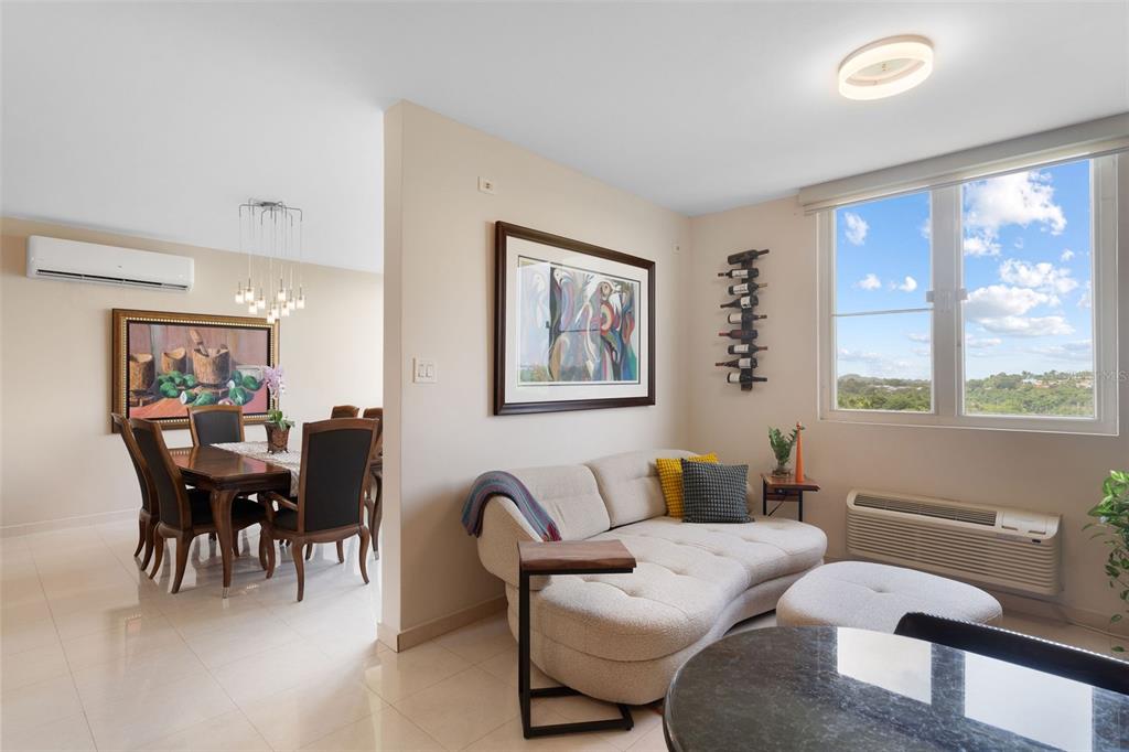 1 Palma Real Avenue, Unit 2 A6 Guaynabo, PR 00969 - Photo 13 of 49 a living room with furniture and large windows