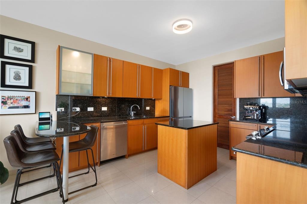 1 Palma Real Avenue, Unit 2 A6 Guaynabo, PR 00969 - Photo 16 of 49 a kitchen with stainless steel appliances granite countertop a stove a sink and a refrigerator