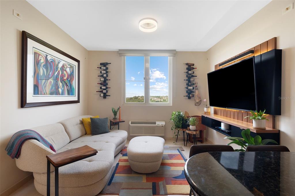1 Palma Real Avenue, Unit 2 A6 Guaynabo, PR 00969 - Photo 18 of 49 a living room with furniture and a flat screen tv