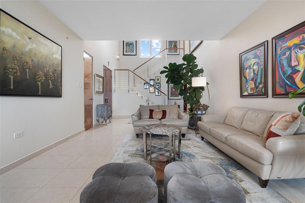1 Palma Real Avenue, Unit 2 A6 Guaynabo, PR 00969 - Photo 20 of 49 a living room with furniture a couch and paintings on the wall