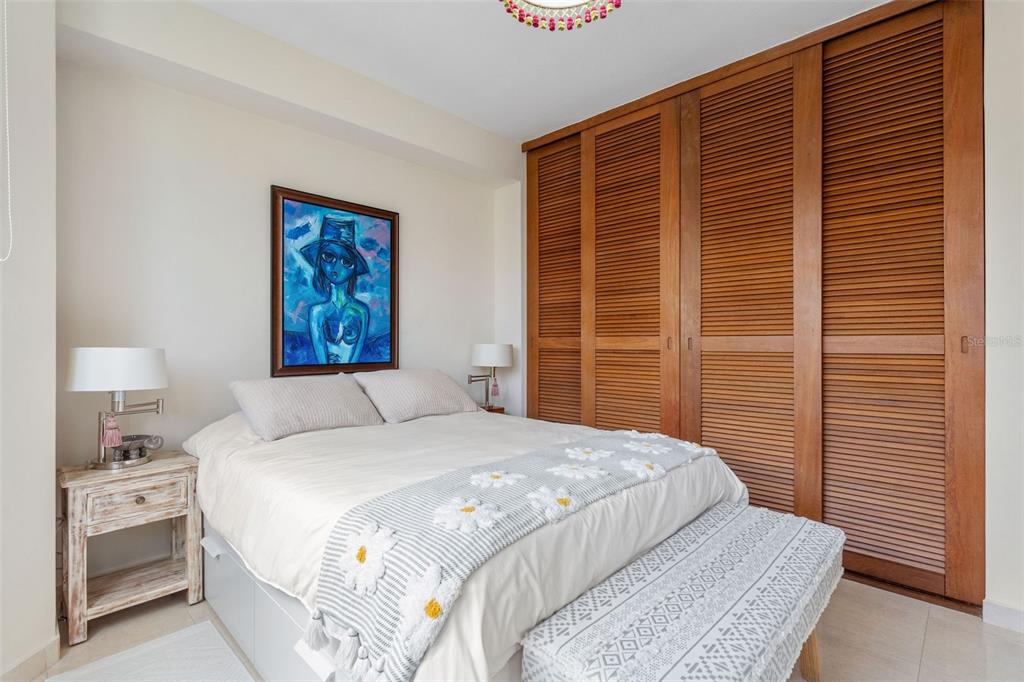 1 Palma Real Avenue, Unit 2 A6 Guaynabo, PR 00969 - Photo 24 of 49 a bedroom with a bed and a lamp on dresser