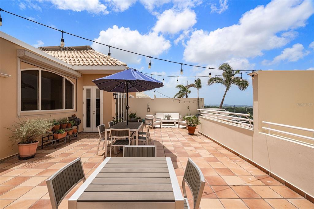 1 Palma Real Avenue, Unit 2 A6 Guaynabo, PR 00969 - Photo 30 of 49 a view of a patio with a table chairs and a barbeque