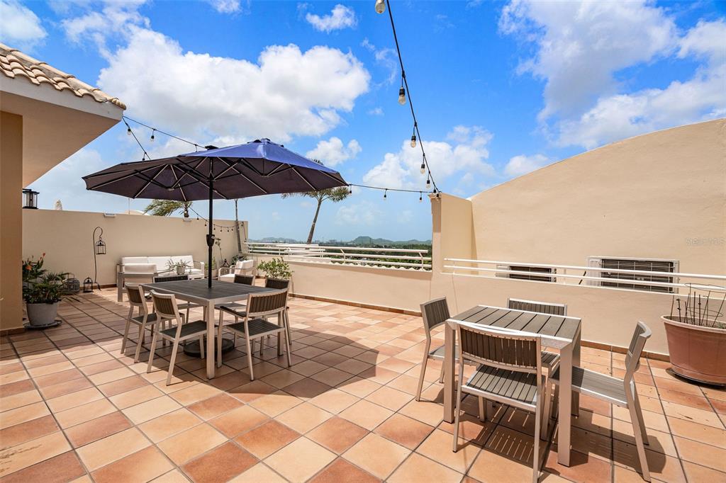 1 Palma Real Avenue, Unit 2 A6 Guaynabo, PR 00969 - Photo 32 of 49 a view of a dinning table and chairs in the patio