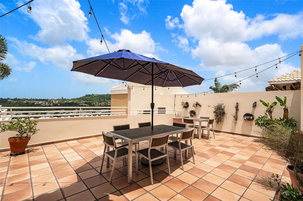 1 Palma Real Avenue, Unit 2 A6 Guaynabo, PR 00969 - Photo 33 of 49 a view of a terrace with furniture and stove