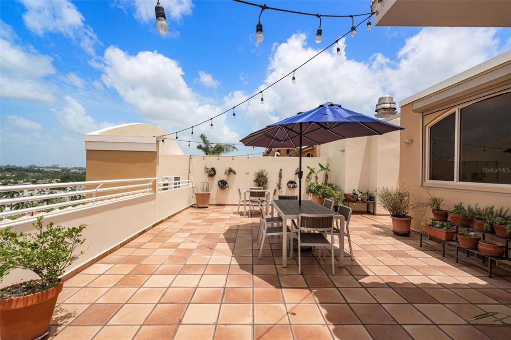 1 Palma Real Avenue, Unit 2 A6 Guaynabo, PR 00969 - Photo 37 of 49 a view of a patio with table and chairs under an umbrella