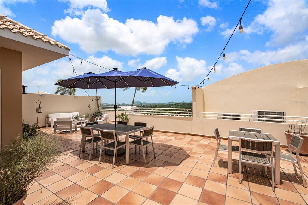 1 Palma Real Avenue, Unit 2 A6 Guaynabo, PR 00969 - Photo 38 of 49 a view of a patio with chairs and tables