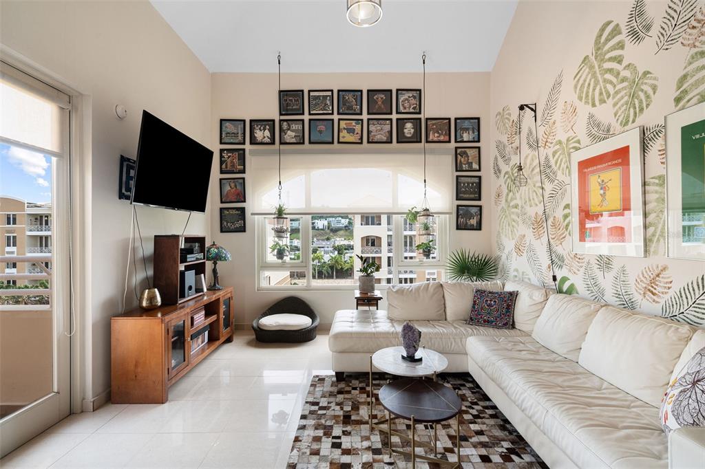 1 Palma Real Avenue, Unit 2 A6 Guaynabo, PR 00969 - Photo 44 of 49 a living room with furniture a flat screen tv and a floor to ceiling window