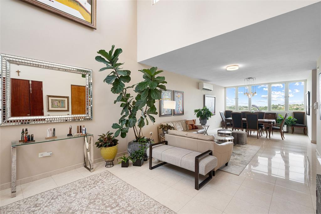 1 Palma Real Avenue, Unit 2 A6 Guaynabo, PR 00969 - Photo 7 of 49 a living room with furniture and a potted plant