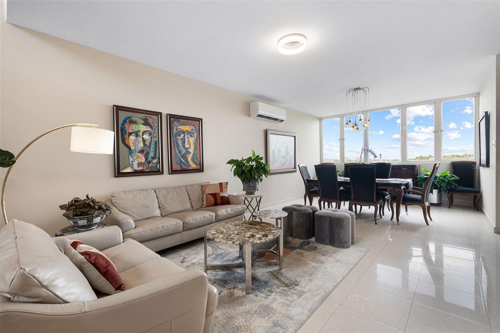 1 Palma Real Avenue, Unit 2 A6 Guaynabo, PR 00969 - Photo 9 of 49 a living room with furniture potted plant kitchen view and a window