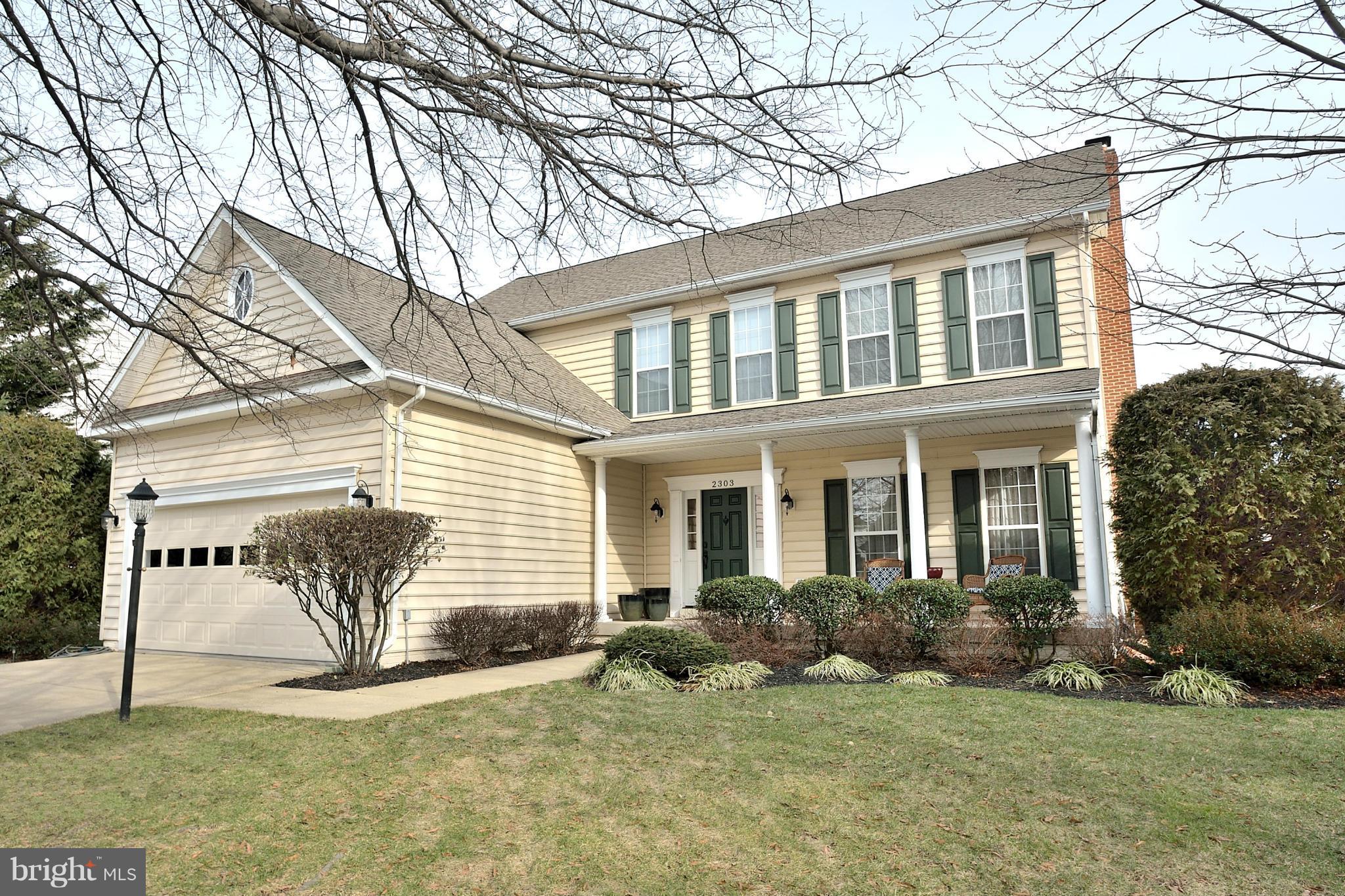 a view of a house with backyard and a tree