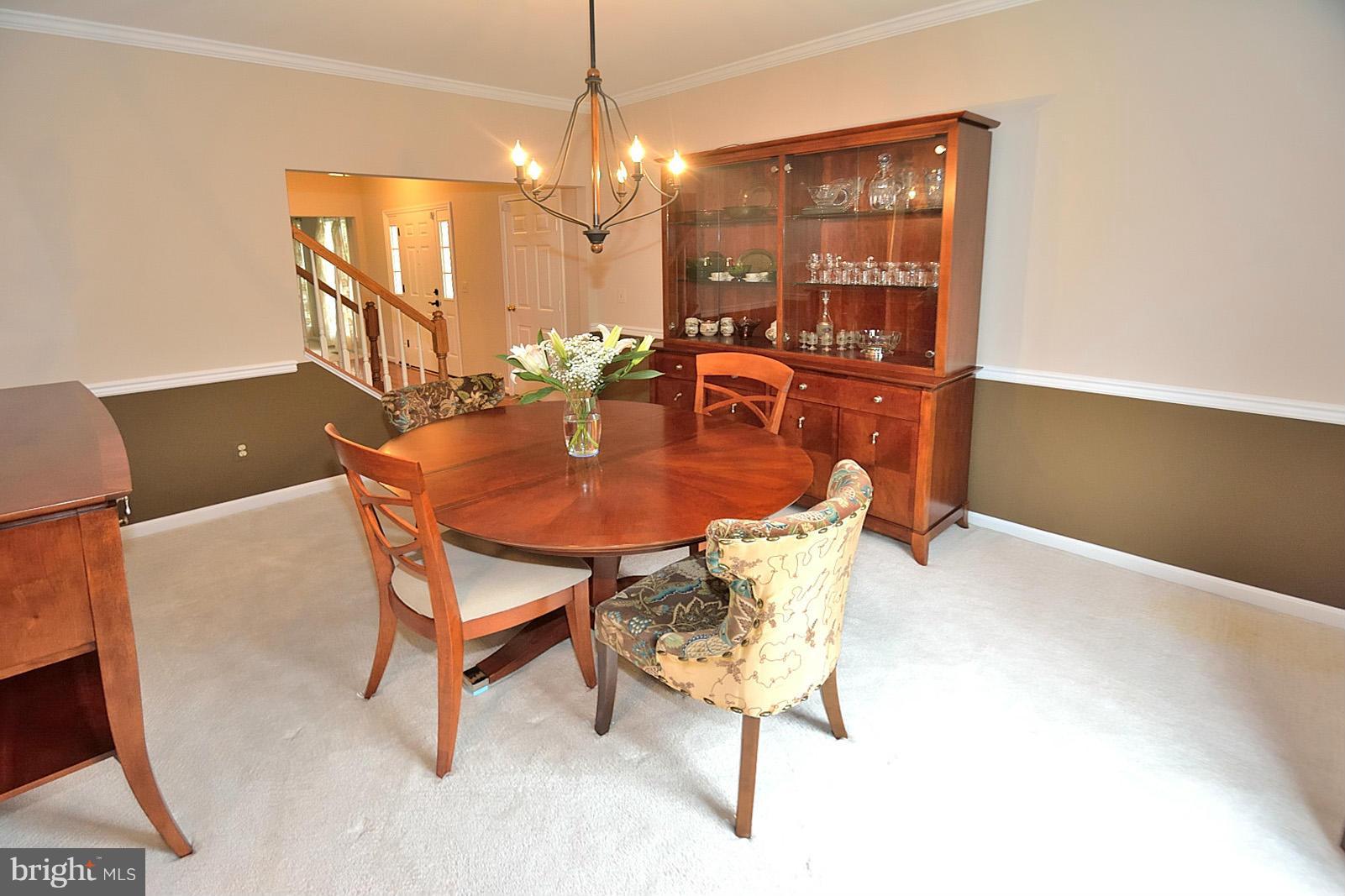 2303 Hurlingham Lane Reston, VA 20191 - Photo 12 of 30 a dining room with furniture and chandelier or wooden floor